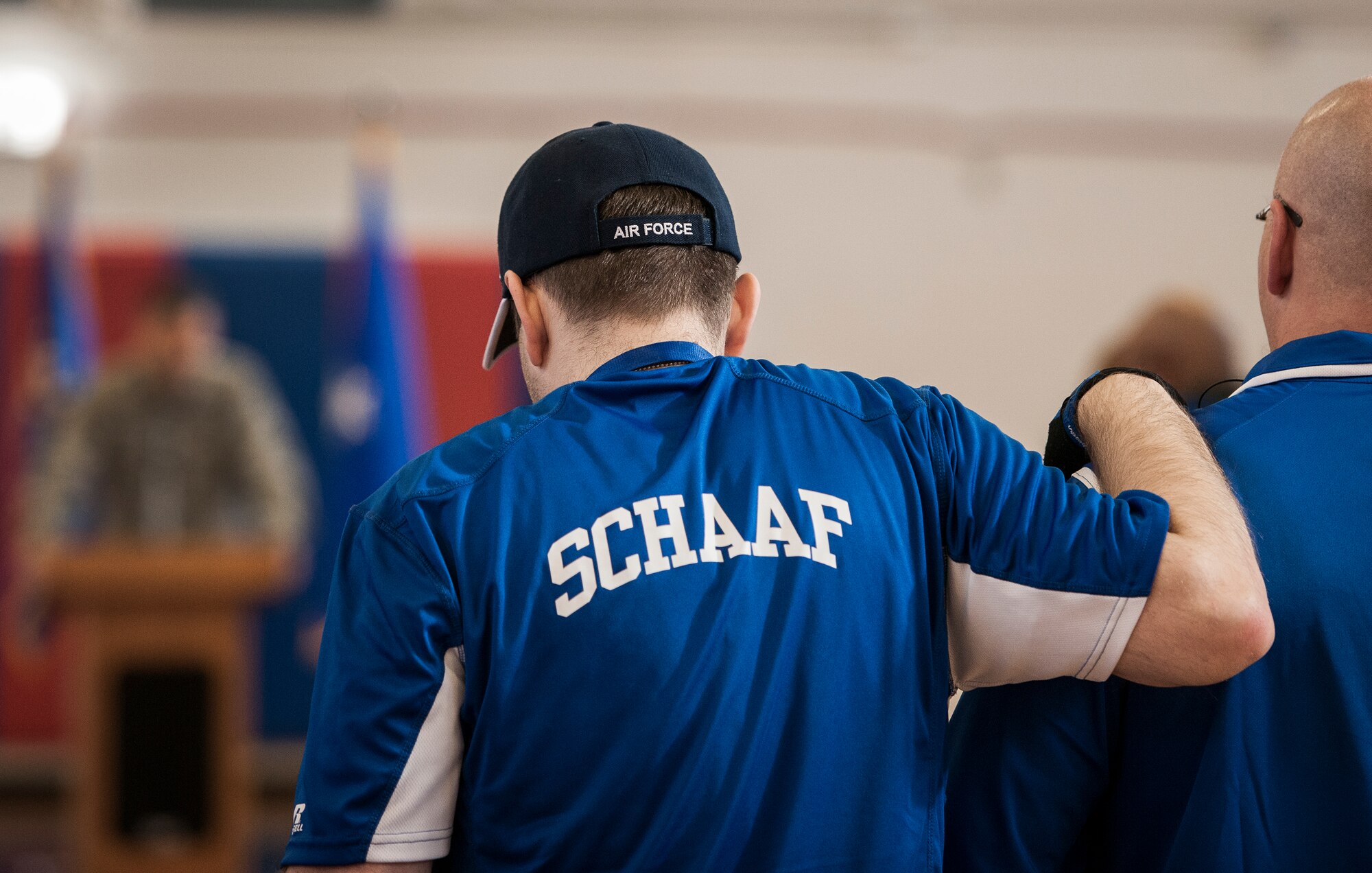 Brian Shaaf, a Warrior Games athlete, uses a friend’s shoulder to stand during a moment of prayer at the opening ceremony for the Warrior CARE and Warrior Games training events April 4 at Eglin Air Force Base, Fla.  The ceremony kicked off a week-long rehabilitative wounded warrior camp as well as a training session for the Air Force Warrior Games athletes.  (U.S. Air Force photo/Samuel King Jr.)