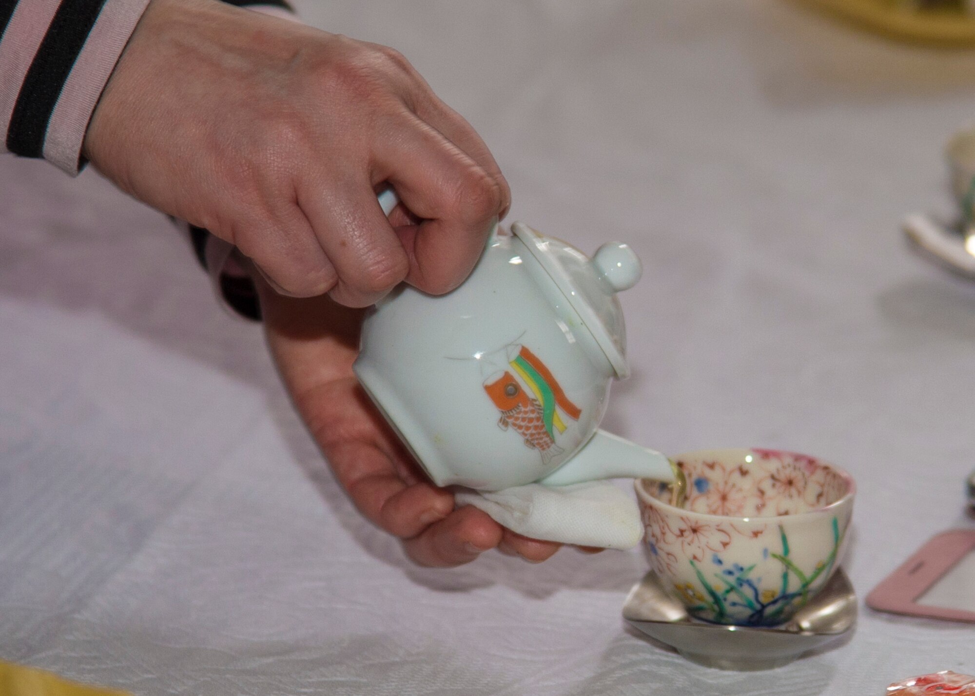 A 29th Annual Japan Day volunteer pours tea at Misawa Air Base, Japan, April 2, 2016. This booth demonstrated the traditional Japanese tea ceremony, a ritual of preparing and serving green tea called Matcha. (U.S. Air Force photo by Airman 1st Class Jordyn Fetter)