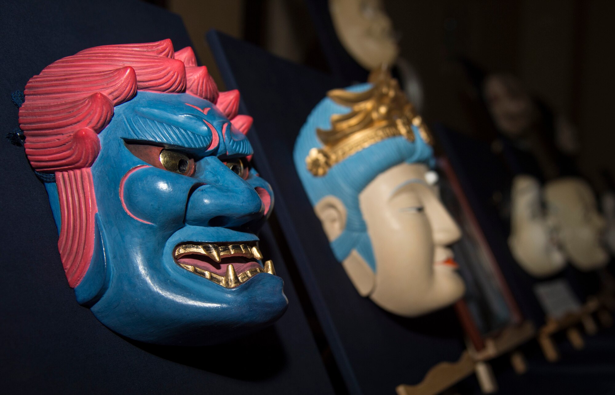 Japanese hand-carved wooden Noh masks line a table during the 29th Annual Japan Day at Misawa Air Base, Japan, April 2, 2016. The Noh mask is used during Japanese theatre productions and is used to represent different characters like elders, women, demons, ghosts and spirits. (U.S. Air Force photo by Airman 1st Class Jordyn Fetter)