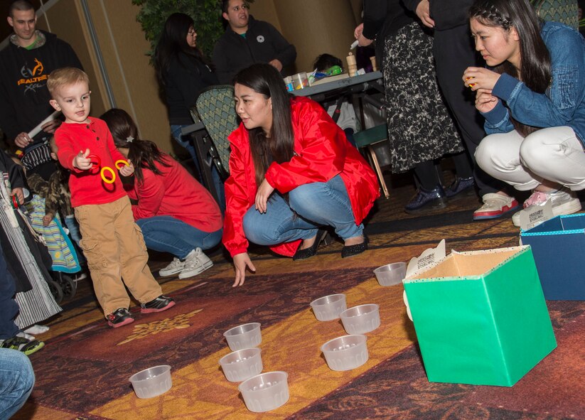 A child attending the 29th Annual Japan Day plays a ring toss game at Misawa Air Base, Japan, April 2, 2016. This year’s festival brought more than 2,000 attendees from the local community to experience various facets of Japanese culture. (U.S. Air Force photo by Airman 1st Class Jordyn Fetter)