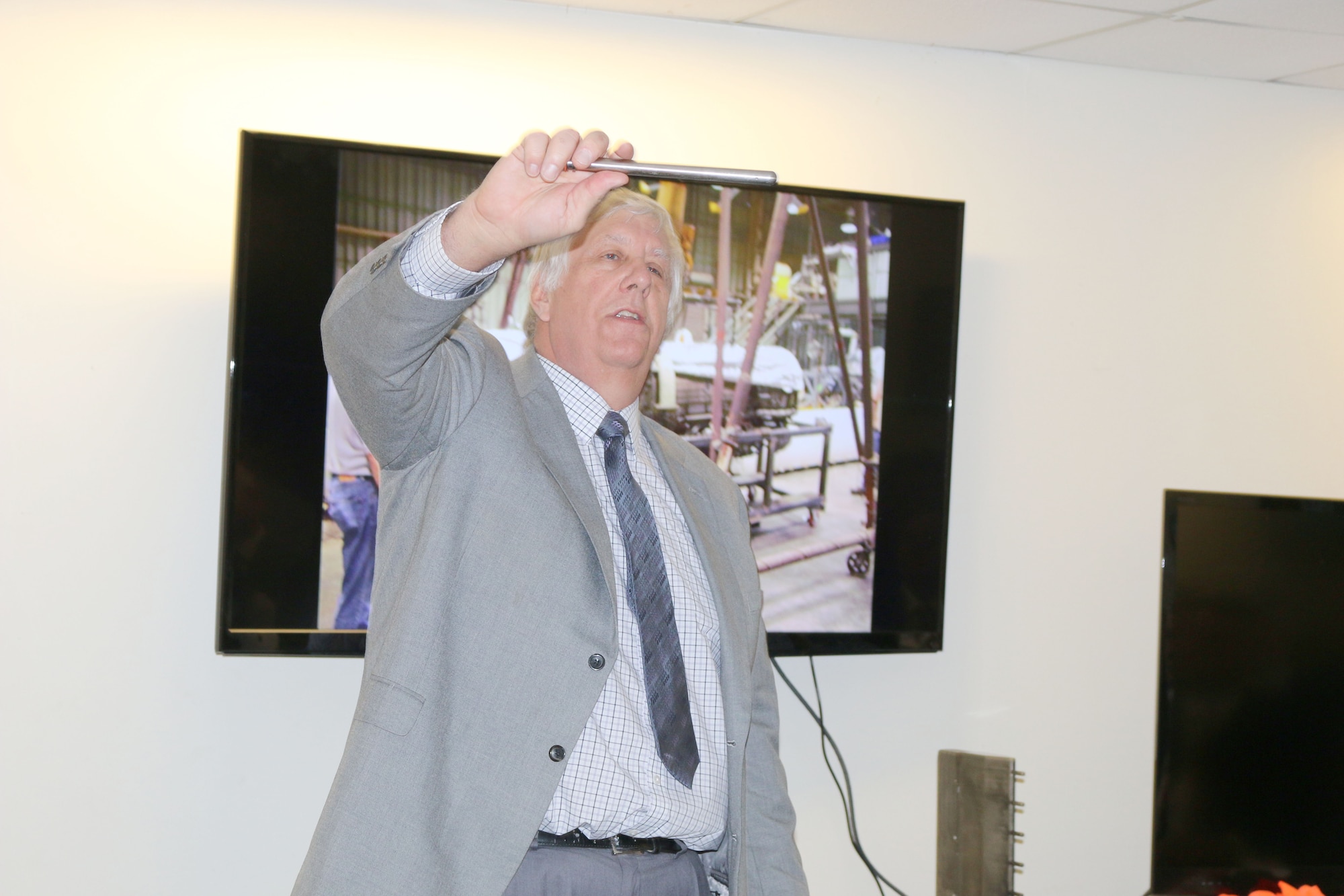 Brad Winkleman, ATA engineer who worked closely with Gregg Beitel, spoke at the dedication ceremony March 18 at University of Tennessee Space Institute. Winkleman holds up a metal probe used as part of the Propulsion Research Facility test stand and explains to the crowd its purpose. He also noted that, like the metal probe, Beitel was strong in his determination to make sure the PRF was a success. (U.S. Air Force photo/Deidre Ortiz) 