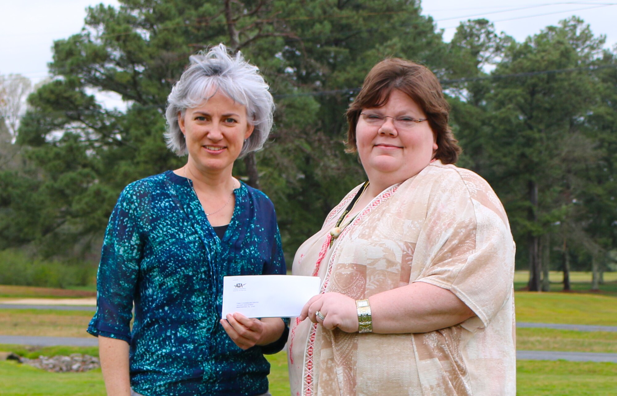 The ATA Employee and Community Activities Committee recently made a donation to the Family Counseling Center which operates the Contact Lifeline of the Highland Rim, a free crisis hotline for residents of Bedford, Coffee, Franklin and Moore counties. Ellen Stowers (right), a program services coordinator with FCC, receives the donation from E&CAC Treasurer Kristi Martin that will be used to support the crisis line services and crisis intervention training for the volunteer staff. (U.S. Air Force photo/Holly Fowler)