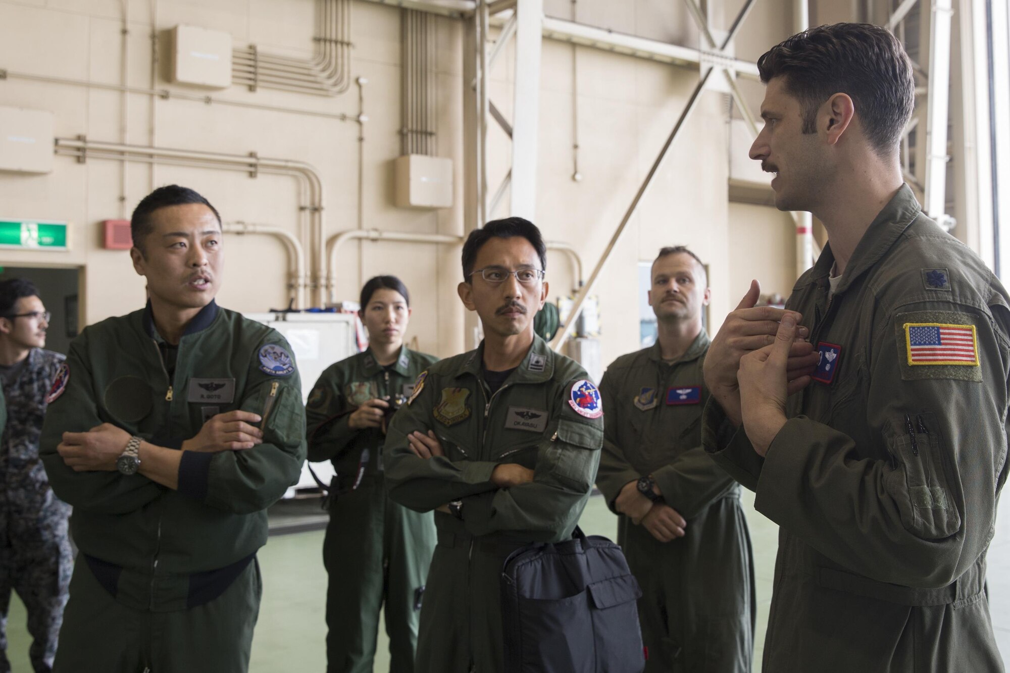 (Right to left) U.S. Air Force Lt. Col. William Marin, 459th Airlift Squadron commander, briefs Japan Air Self-Defense Force members of the 402nd Squadron, at Yokota Air Base, Japan, March 30, 2016. Members from the 459 AS demonstrated Aeromedical Evacuation procedures with a C-12 Huron to JASDF members to introduce AE operations and the AE Spectrum Bed. (U.S. Air Force photo by Yasuo Osakabe/Released)