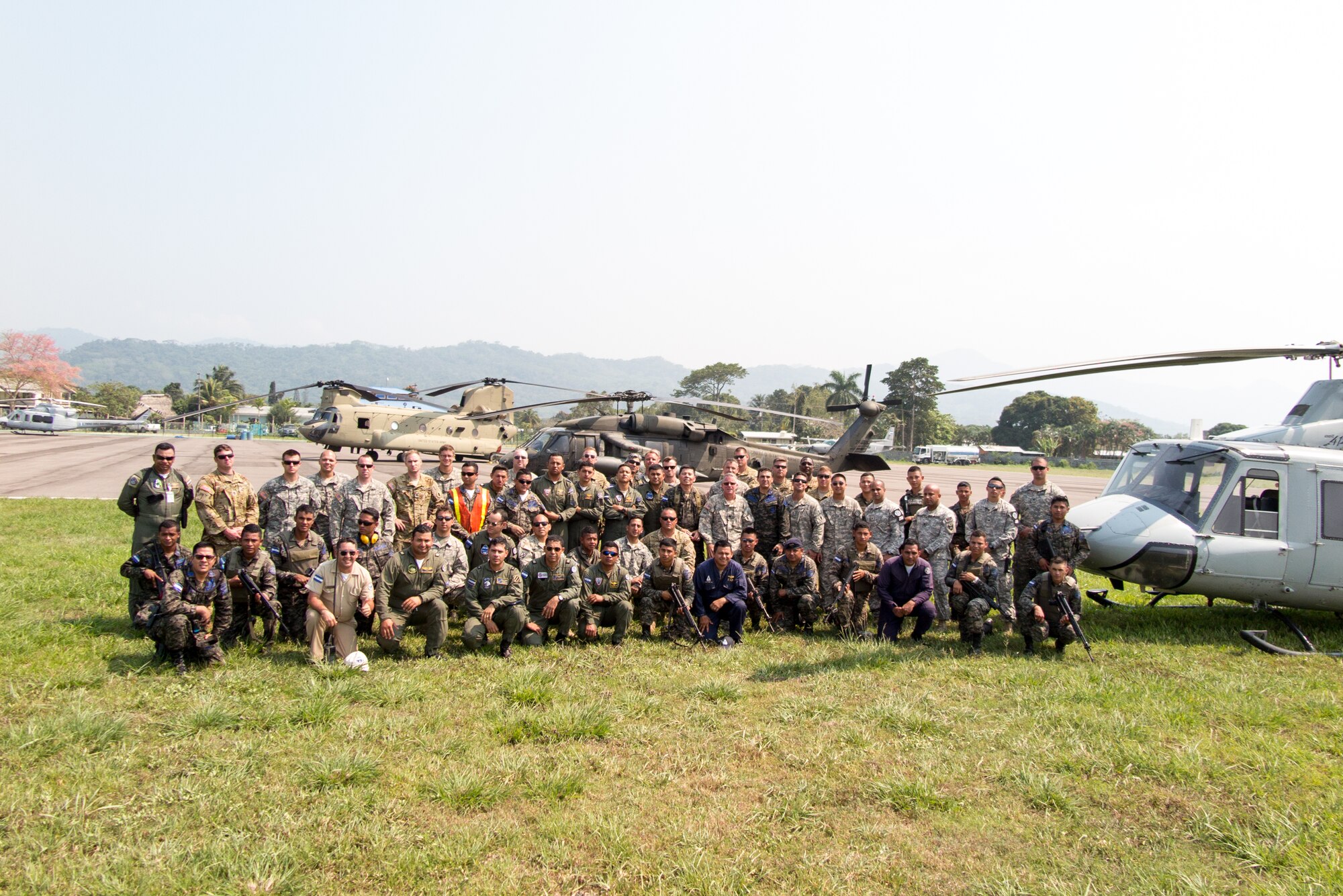 Representatives from the Honduran Fire Department, Air Force and Army pose for a group photo with U.S. Servicemembers from Joint Task Force-Bravo, 1-228th Aviation Regiment after working together in firefighting mission near Tela, Honduras, April 02, 2016. The U.S. responded to the request of Honduran President Juan Orlando Hernandez to assist the Honduran forces with air capabilities to extinguish the forest fire in Jeanette Kawas National Park. (Courtesy photo by Chief Warrant Officer Kyle Johnson)