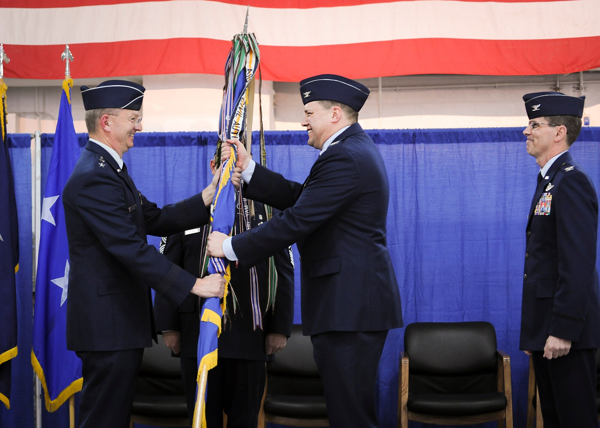 Col. Michael Smith, 174th Attack Wing commander, receives the wing's colors from Maj. Gen. Anthony German, the commander of the New York Air National Guard, during the change of command ceremony held at Hancock Field Air National Guard Base, April 3. (U.S. Air National Guard photo by Tech. Sgt. Jeremy Call/Released)
