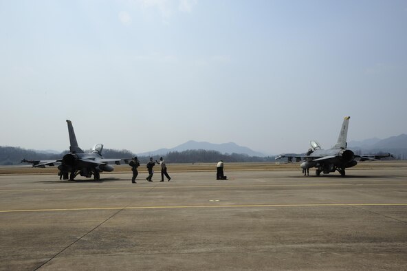 Airmen from the 80th Aircraft Maintenance Unit and pilots from the 80th Fighter Squadron greet one another before a post-flight inspection during Buddy Wing 16-3 at Jungwon Air Base, South Korea, March 30, 2016. Buddy Wing training, held multiple times a year, polishes the ability of the South Korea air force and U.S. Air Force Airmen to train and operate as a combined force. (U.S. Air Force photo/Staff Sgt. Nick Wilson)