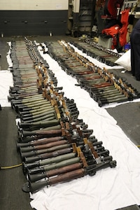 (March 31, 2016) A cache of weapons is assembled on the deck of the guided-missile destroyer USS Gravely (DDG 107). The weapons were seized from a stateless dhow, which was intercepted by the Coastal Patrol ship USS Sirocco (PC 6) on March 28. The illicit cargo included 1,500 AK-47s, 200 RPG launchers, and 21 .50 caliber machine guns. Gravely supported the seizure following the discovery of the weapons by Sirocco's boarding team. This seizure was the third time in recent weeks international naval forces operating in the waters of the Arabian Sea seized a shipment of illicit arms, which the United States assessed, originated in Iran and was likely bound for Houthi insurgents in Yemen. The weapons are now in U.S. custody awaiting final disposition. 