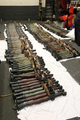 (March 31, 2016) A cache of weapons is assembled on the deck of the guided-missile destroyer USS Gravely (DDG 107). The weapons were seized from a stateless dhow, which was intercepted by the Coastal Patrol ship USS Sirocco (PC 6) on March 28. The illicit cargo included 1,500 AK-47s, 200 RPG launchers, and 21 .50 caliber machine guns. Gravely supported the seizure following the discovery of the weapons by Sirocco's boarding team. This seizure was the third time in recent weeks international naval forces operating in the waters of the Arabian Sea seized a shipment of illicit arms, which the United States assessed, originated in Iran and was likely bound for Houthi insurgents in Yemen. The weapons are now in U.S. custody awaiting final disposition. 