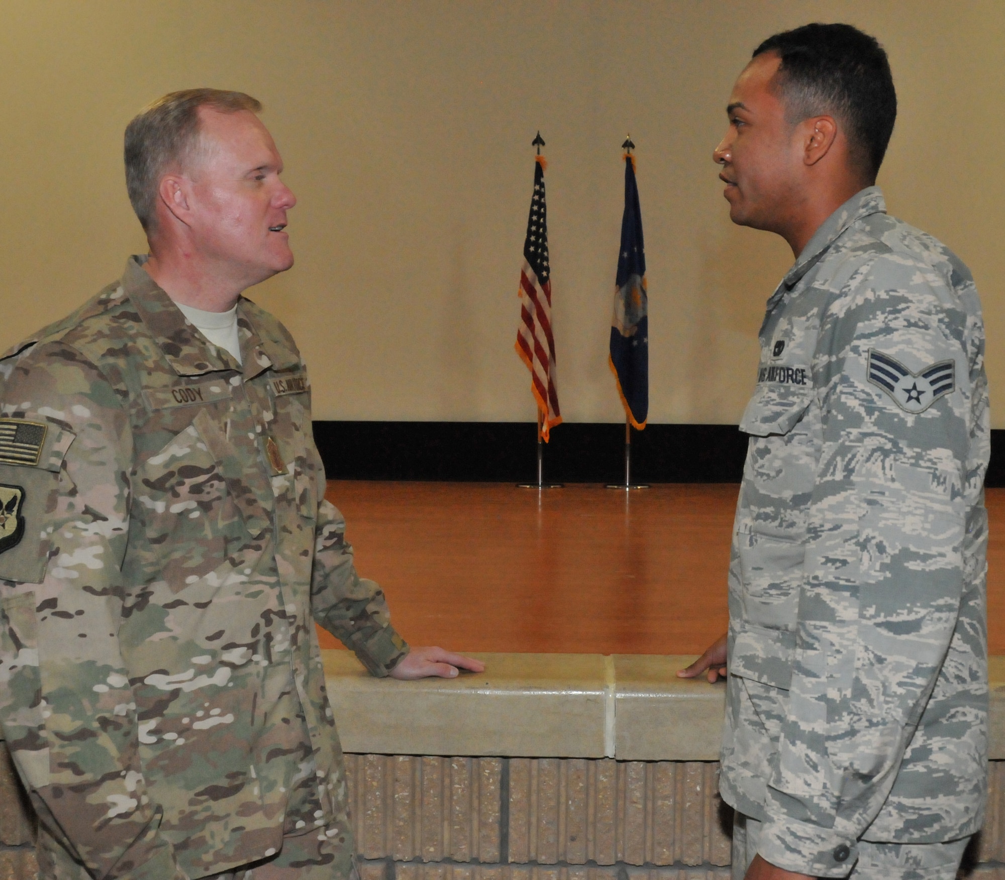 Chief Master Sgt. of the Air Force, James Cody, discusses joint spouse options with Senior Airman Shawn Goodman, 379th Expeditionary Logistic Readiness Squadron vehicle operator, April 4 at Al Udeid Air Base, Qatar. Cody answered questions during and after the all call here on various Airmen concerns and issues. (U.S. Air Force photo by Tech. Sgt. Terrica Y. Jones/Released)