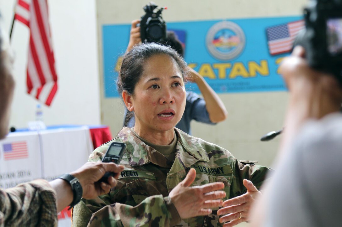 Major Marie O. Reed, 322nd Civil Affairs Brigade, 9th Mission Support Command, medical planner and operations intelligence officer of Exercise Balikatan 2016, addresses the media at a press conference following the opening ceremony for the exercise at Camp Peralta, Panay, Philippines, April 4, 2016. The ceremony signified the official start of the annual bilateral exercise that will run from 4-16 April. In Panay, Balikatan 2016 will consist of medical, dental, veterinary, and engineering civic actions, as part of humanitarian civic assistant projects. AFP and the U.S. military will work together to strengthen their longstanding alliance and to enhance the security and stability of the Philippine nation.