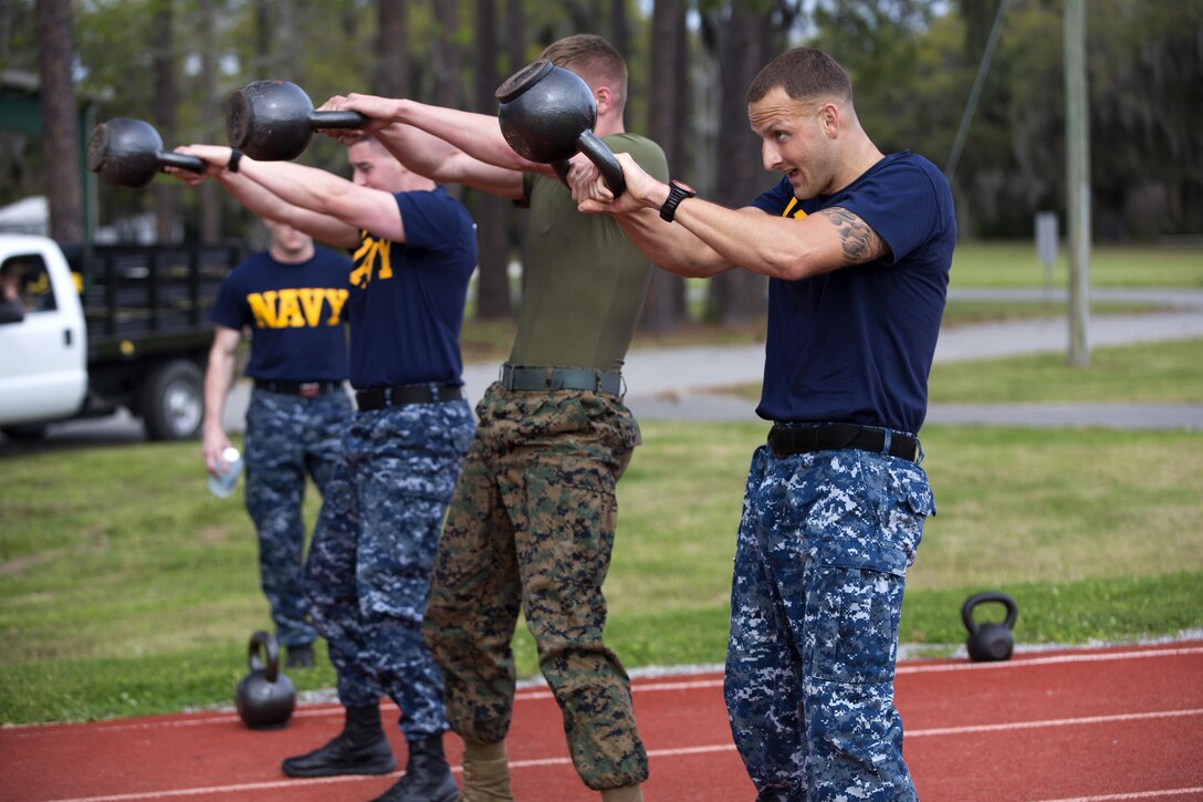 Marines and sailors do kettle bell swings during the Commanding General's Fitness Cup challenge at Marine Corps Recruit Depot Parris Island, S.C., March 25, 2016. Marine Corps photo by Lance Cpl. Richard Currier 