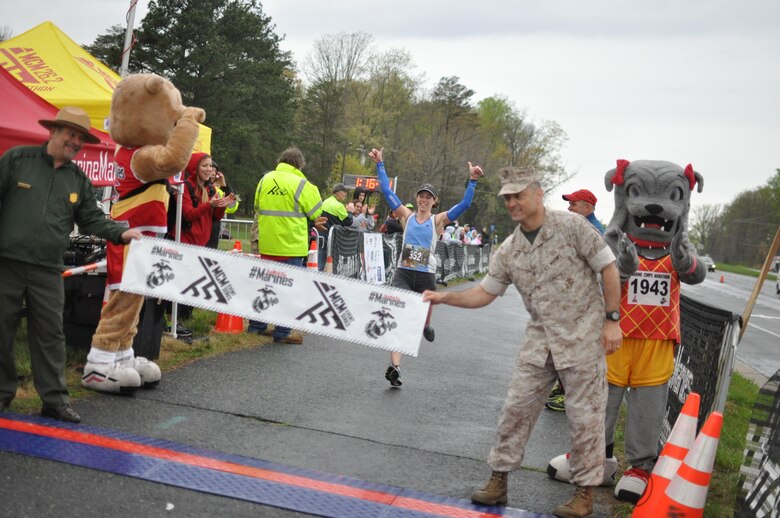 Sharon Schmidt-Mongrain, a 40-year-old runner from Lafayette Hill, Pennsylvania, is the female lead of the Marine Corps Marathon 17.75K run with a completion time of 1:16:12. The race honors the year 1775, which marks the formation of the Marine Corps.