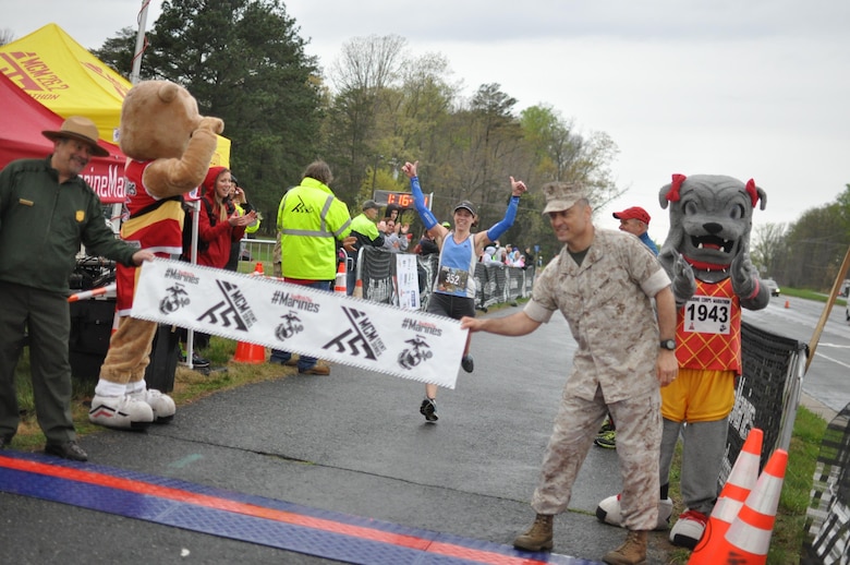 Sharon Schmidt-Mongrain, a 40-year-old runner from Lafayette Hill, Pennsylvania, is the female lead of the Marine Corps Marathon 17.75K run with a completion time of 1:16:12. The race honors the year 1775, which marks the formation of the Marine Corps.