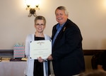 John Kurtz receives the DLA Meritorious Civilian Service Award from DLA Distribution deputy commander Twila Gonzales, Senior Executive Service, at a March 17 retirement ceremony. 