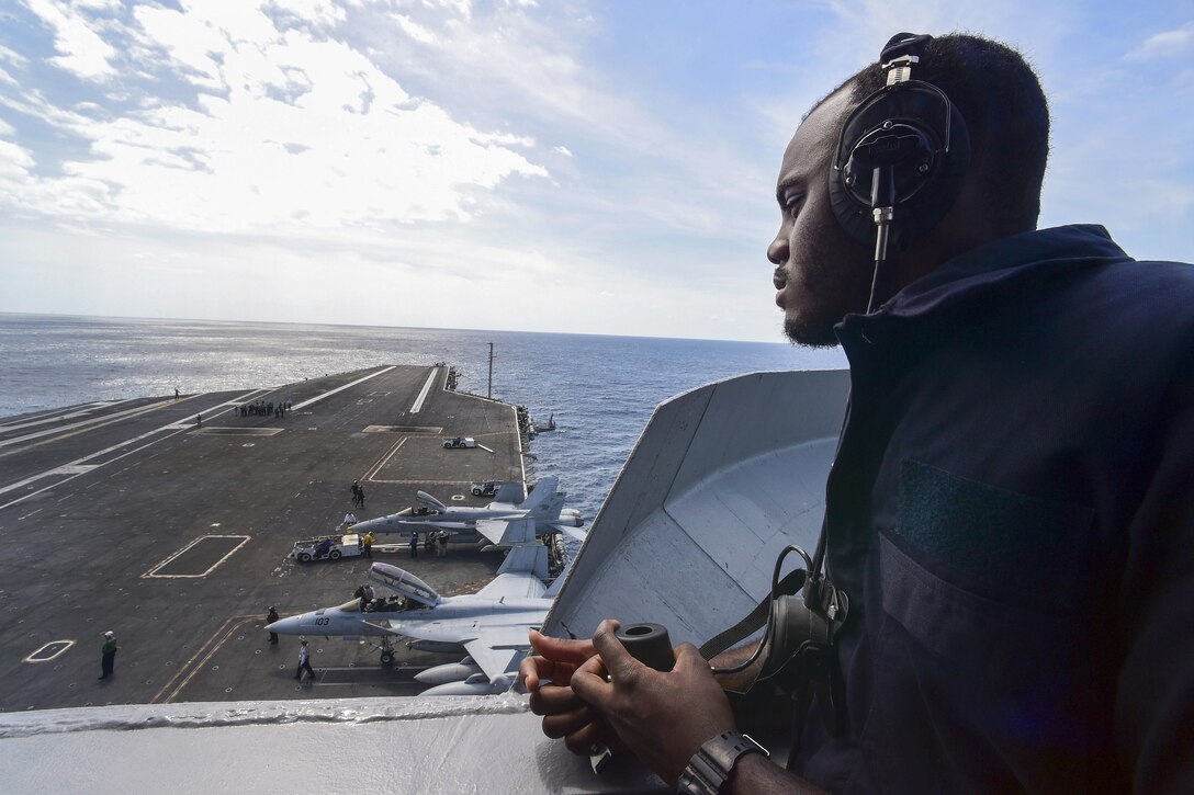 Seaman Derrik Luster stands forward lookout watch aboard the aircraft carrier USS Dwight D. Eisenhower in the Atlantic Ocean, March 24, 2016. Navy photo by Petty Officer 3rd Class Jameson E. Lynch