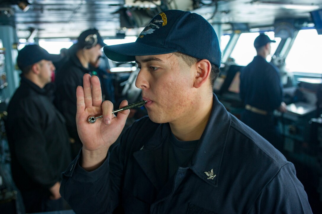 Navy Petty Officer 3rd Class Marco Gomez practices using a boatswain's pipe onboard the aircraft carrier USS Dwight D. Eisenhower in the Atlantic Ocean, March 25, 2016. Gomez is a boatswain’s mate. Navy photo by Seaman Matthew Thompson
