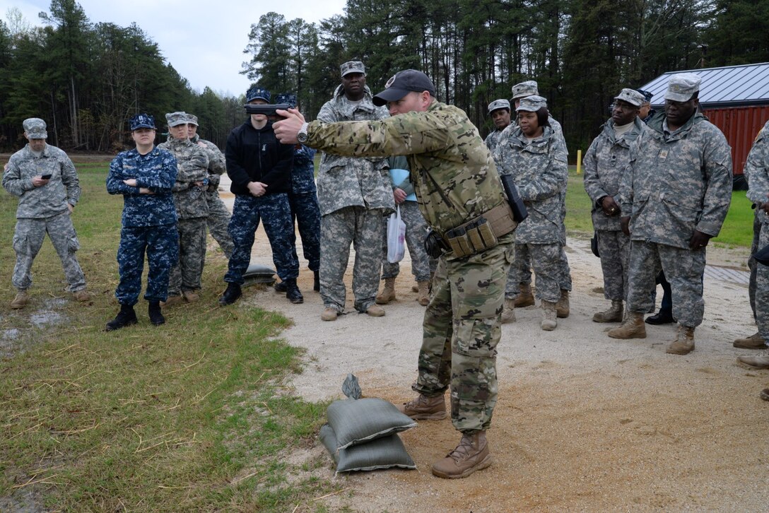 1st Sgt. Tony McCarty instructs DLA JRF members and other soldiers on proper shooting techniques during weapons training April 1 at Fort A.P. Hill, Va.