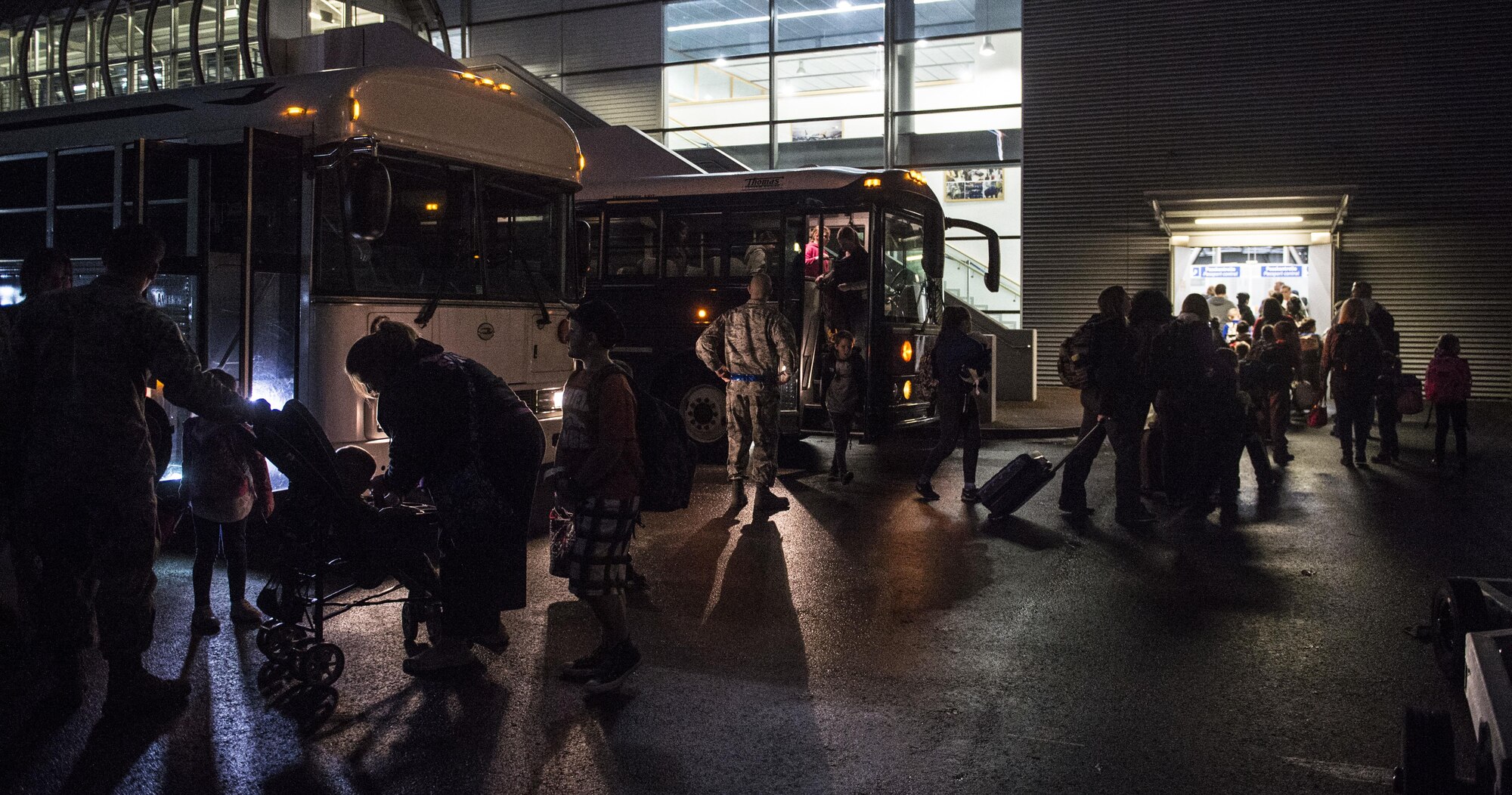 Families affected by the ordered departure of dependents of service members and Defense Department civilian personnel currently stationed in Turkey arrive at Ramstein Air Base, Germany, March 30, 2016. As dependents departed Turkey, Ramstein AB has been designated as a “transition location” for families to await travel to their subsequent duty locations. (U.S. Air Force photo/Staff Sgt. Sara Keller)