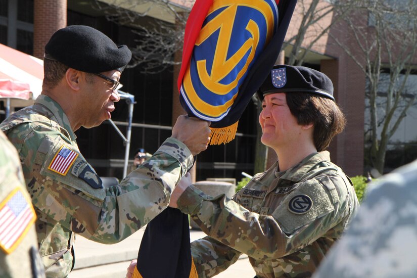 Maj. Gen. A. C. Roper, the commanding general of the 80th Training Command (TASS), passes the colors of the 102nd Training Division (Maneuver Support) to the 102nd's incoming commander, Brig. Gen. Miyako Schanely, in a symbolic gesture representing the transfer of authority from outgoing commander Brig. Gen. John Elam to Schanely during a Change of Command ceremony at Ft. Leonard Wood, Mo., April 3, 2016.  The 102nd trains engineers, military police, and CBRN (chemical, biological, radiological, and nuclear) soldiers across the United States.