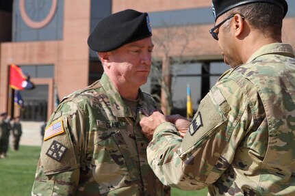 Maj. Gen. A. C. Roper, the commander of the 80th Training Command (TASS), awards the prestigious Legion of Merit award to the 102nd Training Division's outgoing commmander, Brig. Gen. John Elam, to honor Elam's years of dedication and service during a Change of Command ceremony at Ft. Leonard Wood, Mo., March 3, 2016.  Elam, along with Command Sgt. Maj. John Stumph, handed the reins of leadership of the 102nd over to the new commander, Brig. Gen. Miyako Schanely, and Command Sgt. Maj. Robert Provost.  The 102nd trains engineers, military police, and CBRN (chemical, biological, radiological, and nuclear) soldiers across the United States.