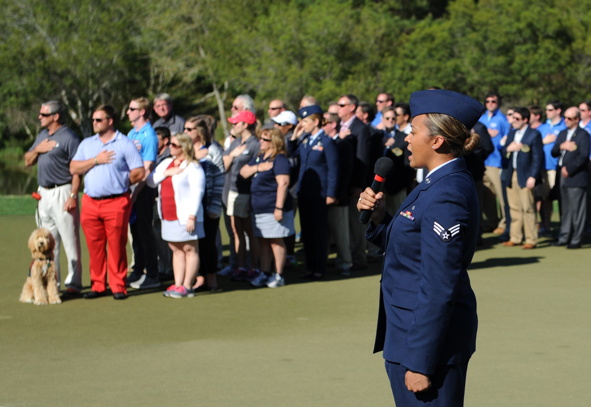 Senior Airman Sydney Parker, 81st Dental Squadron dental technician, sings the national anthem during the Mississippi Gulf Resort Classic closing ceremonies at the Fallen Oak Golf Course April 3, 2016. Col. Michele Edmondson, 81st Training Wing commander, Keesler Airmen and the base honor guard also participated in the festivities. (U.S. Air Force photo by Kemberly Groue)