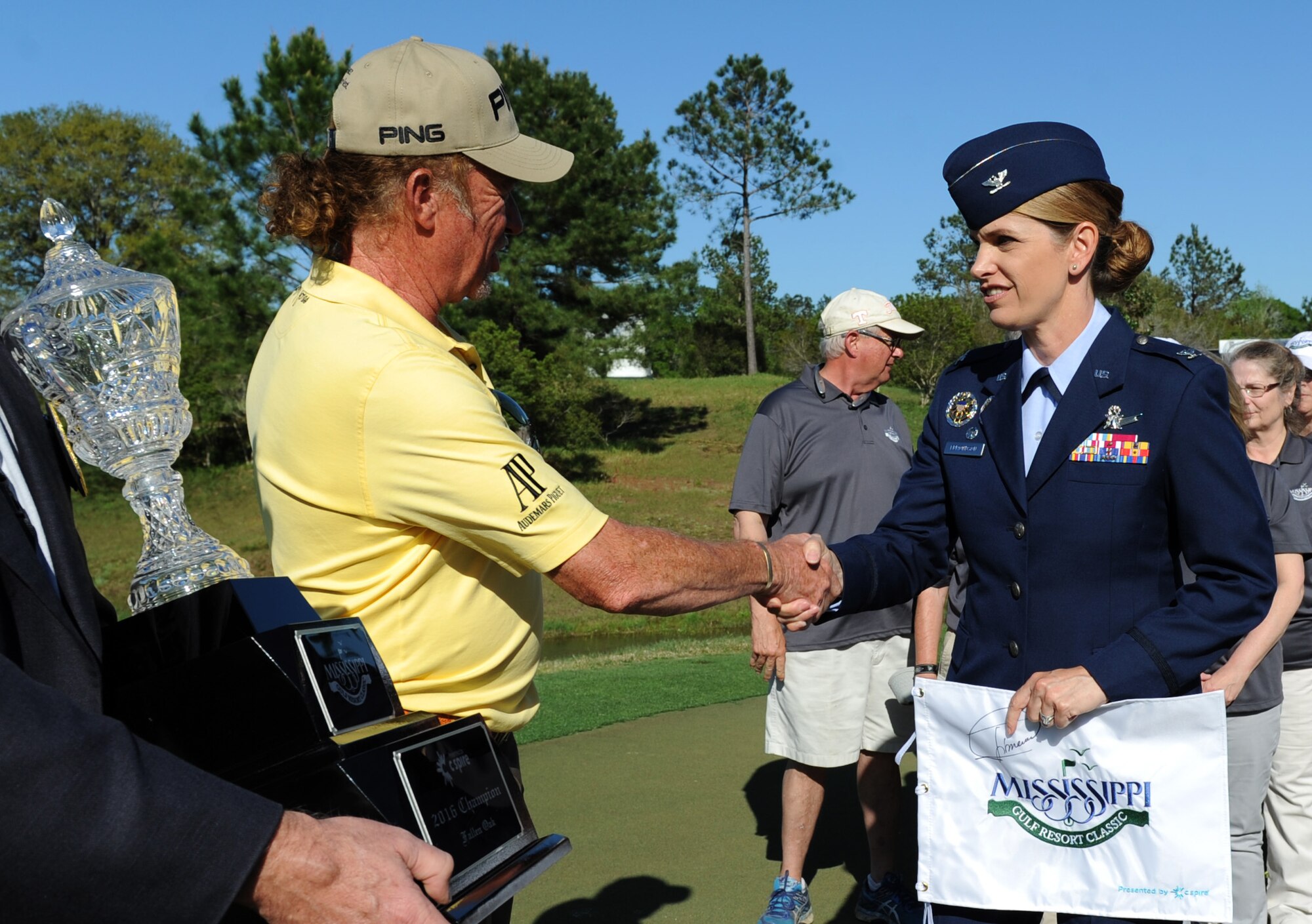 Miguel Jimenez, professional golfer, is congratulated by Col. Michele Edmondson, 81st Training Wing commander, after being presented as the champion of the Mississippi Gulf Resort Classic at the Fallen Oak Golf Course April 3, 2016. Keesler Airman volunteers and the base honor guard also participated in the closing ceremonies. (U.S. Air Force photo by Kemberly Groue)