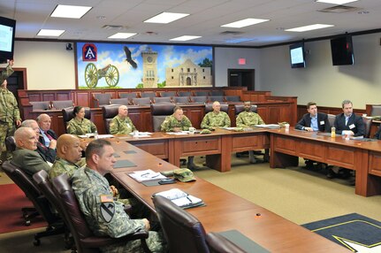 Maj. Gen. James ‘Boe’ Young, commander, 75th Training Command (center), briefs staff delegates from Washington D.C. about the role his unit plays in the Army Reserve, March 29, Fort Sam Houston, Texas. Listening are staff delegates Darrell Owens (second left), legislative assistant for Senator Pat Toomey (R-PA), and James Baker (left), a senior legislative assistant.