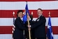 Maj. Gen. Stayce Harris, 22nd Air Force commander, passes the 302nd Airlift Wing guide on to Col. James DeVere during an assumption of command ceremony April 2, 2016, Peterson Air Force Base, Colo. DeVere comes to the 302AW from Dobbins Air Reserve Base, Ga., where he was the 94th Operations Group commander. (U.S. Air Force photo/Staff Sgt. Amber Sorsek)