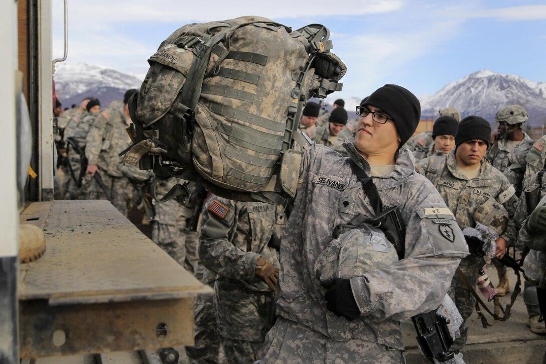 Army Spc. Andre Selivanov loads his pack onto a truck before participating in a night airborne operation at Joint Base Elmendorf-Richardson, Alaska, March 31, 2016. Selivanov is a paratrooper assigned to the 25th Infantry Division’s 1st Squadron, 40th Cavalry Regiment, 4th Brigade Combat Team Airborne. Air Force photo by Alejandro Pena