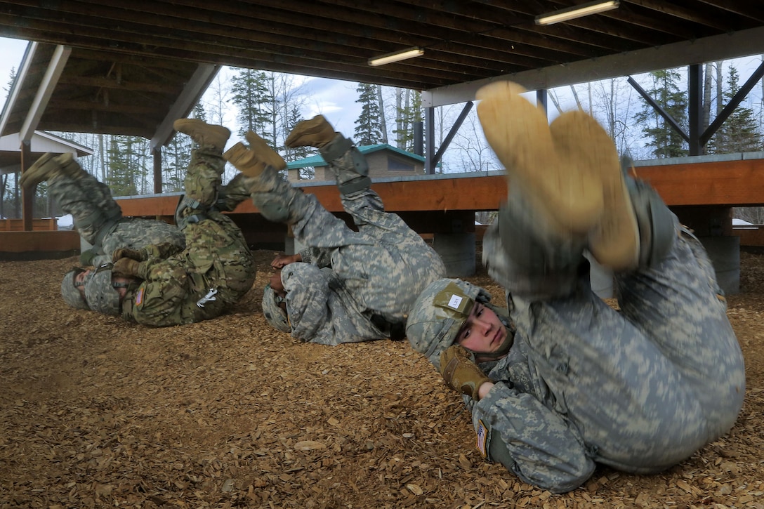 Paratroopers rehearse parachute landing falls before a night airborne operation at Joint Base Elmendorf-Richardson, Alaska, March 31, 2016. Air Force photo by Alejandro Pena