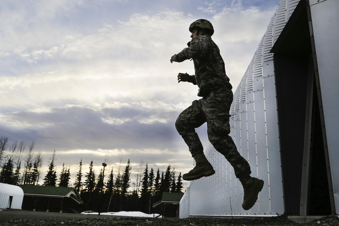 A paratrooper rehearses exiting an aircraft before participating in a night airborne operation at Joint Base Elmendorf-Richardson, Alaska, March 31, 2016. Air Force photo by Alejandro Pena