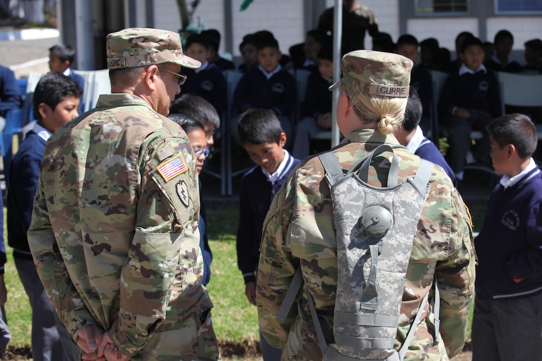 U.S. Army Master Sgt. Santos DeLeon and Sergeant 1st Class Cheylynn Currie talk to school children during the celebration of Guatemala's republic day at San Marcos, April 4th, 2016. Task Force Red Wolf and Army South conducts Humanitarian Civil Assistance Training to include tactical level construction projects and Medical Readiness Training Exercises providing medical access and building schools in Guatemala with the Guatemalan Government and non-government agencies from 05MAR16 to 18JUN16 in order to improve the mission readiness of US Forces and to provide a lasting benefit to the people of Guatemala. (U.S. Army photo by Sgt. Prosper Ndow/Released)
