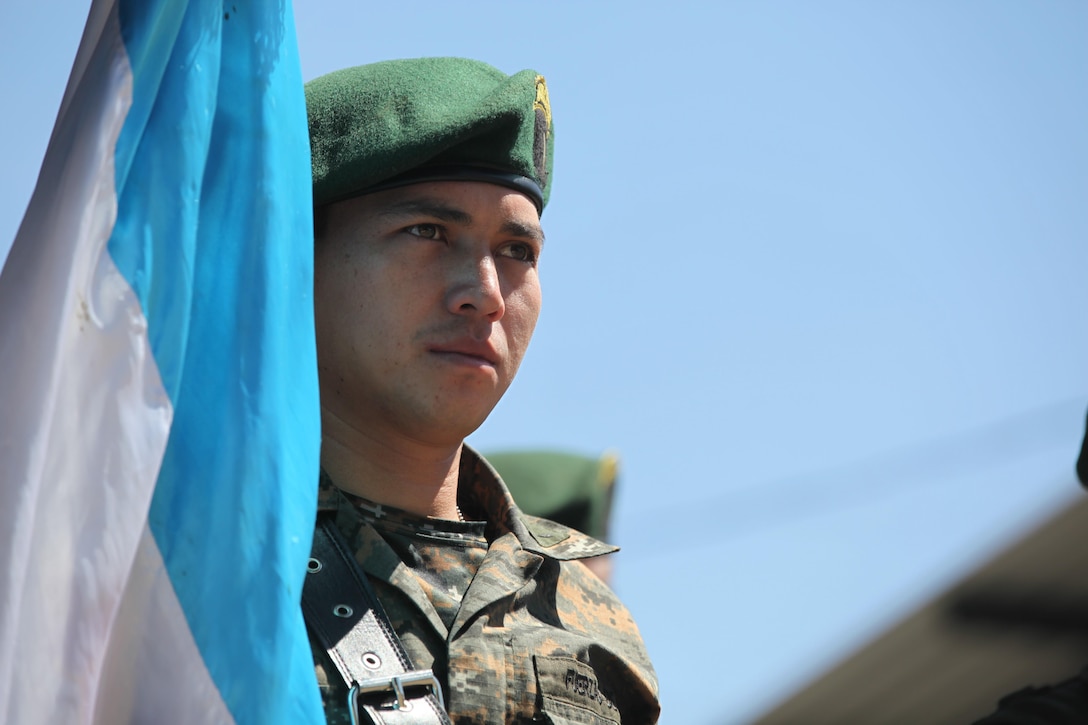 Guatemalan Army member holds the Guatemalan flag during the celebration for Guatemala's republic day at San Marcos, April 4th, 2016. Task Force Red Wolf and Army South conducts Humanitarian Civil Assistance Training to include tactical level construction projects and Medical Readiness Training Exercises providing medical access and building schools in Guatemala with the Guatemalan Government and non-government agencies from 05MAR16 to 18JUN16 in order to improve the mission readiness of US Forces and to provide a lasting benefit to the people of Guatemala. (U.S. Army photo by Sgt. Prosper Ndow/Released)