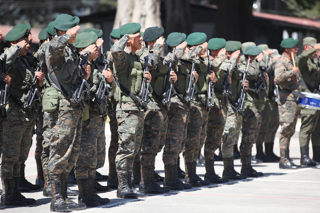 Guatemalan Army members render a salute during the playing of the Guatemala national anthem for the celebration of Guatemala's republic day at San Marcos, April 4th, 2016. Task Force Red Wolf and Army South conducts Humanitarian Civil Assistance Training to include tactical level construction projects and Medical Readiness Training Exercises providing medical access and building schools in Guatemala with the Guatemalan Government and non-government agencies from 05MAR16 to 18JUN16 in order to improve the mission readiness of US Forces and to provide a lasting benefit to the people of Guatemala. (U.S. Army photo by Sgt. Prosper Ndow/Released)
