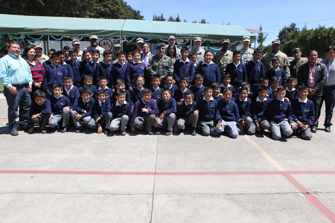 School children from Escuela Oficil Urbana pose for photos with U.S. and Guatemalan army members and other dignitaries after the celebration for Guatemala's republic day at San Marcos, April 4th, 2016. Task Force Red Wolf and Army South conducts Humanitarian Civil Assistance Training to include tactical level construction projects and Medical Readiness Training Exercises providing medical access and building schools in Guatemala with the Guatemalan Government and non-government agencies from 05MAR16 to 18JUN16 in order to improve the mission readiness of US Forces and to provide a lasting benefit to the people of Guatemala. (U.S. Army photo by Sgt. Prosper Ndow/Released)