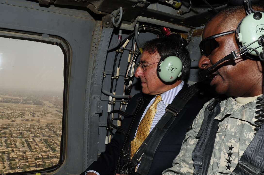 Defense Secretary Leon E. Panetta, left, travels aboard a UH-60 Black Hawk helicopter with Army Gen. Lloyd J. Austin III, the commander of U.S. Forces Iraq, over Baghdad before meeting with Iraqi leaders, July 11, 2011. DoD photo by Air Force Tech. Sgt. Jacob N. Bailey