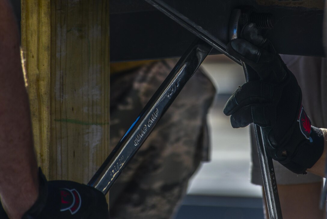 Airmen, assigned to the 555th Red Horse Squadron, secure the bolts that will a part of the roof of the firehouse at Nellis Air Force Base, Nev., April 2, 2016. The reserve squadron gives the 820th RHS a boost in order to complete missions in a much more efficient manner. (U.S. Air Force photo by Airman 1st Class Kevin Tanenbaum)