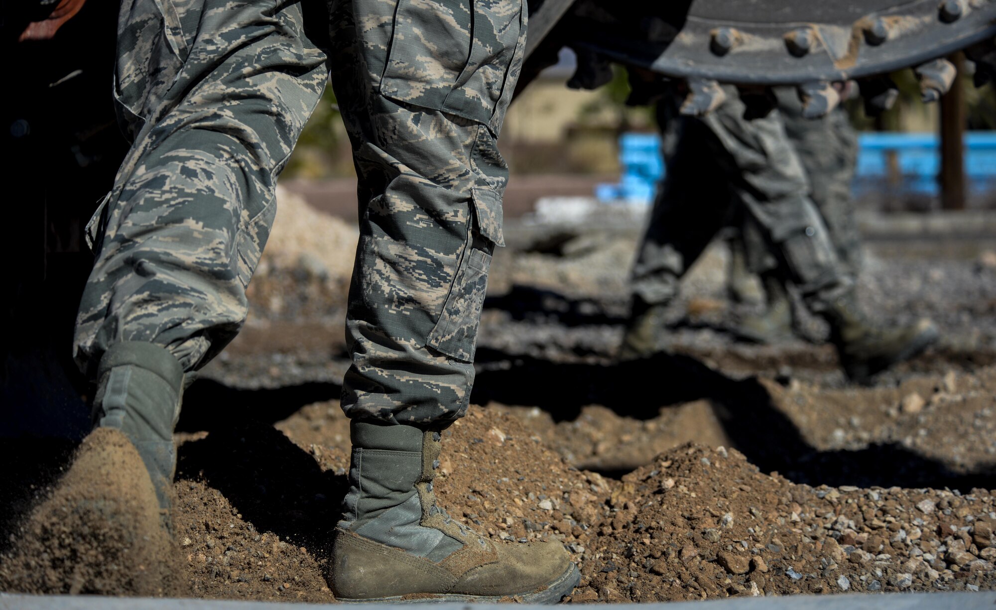 An Airman, assigned to the 555th Red Horse Squadron, kicks the dirt back from the freshly dug trench at Nellis Air Force Base, Nev., April 2, 2016. The contributions that the 555th RHS is able to provide can in part be attributed to how closely the squadron is able to coexist with its sister flight, the 820th RHS. (U.S. Air Force photo by Airman 1st Class Kevin Tanenbaum)