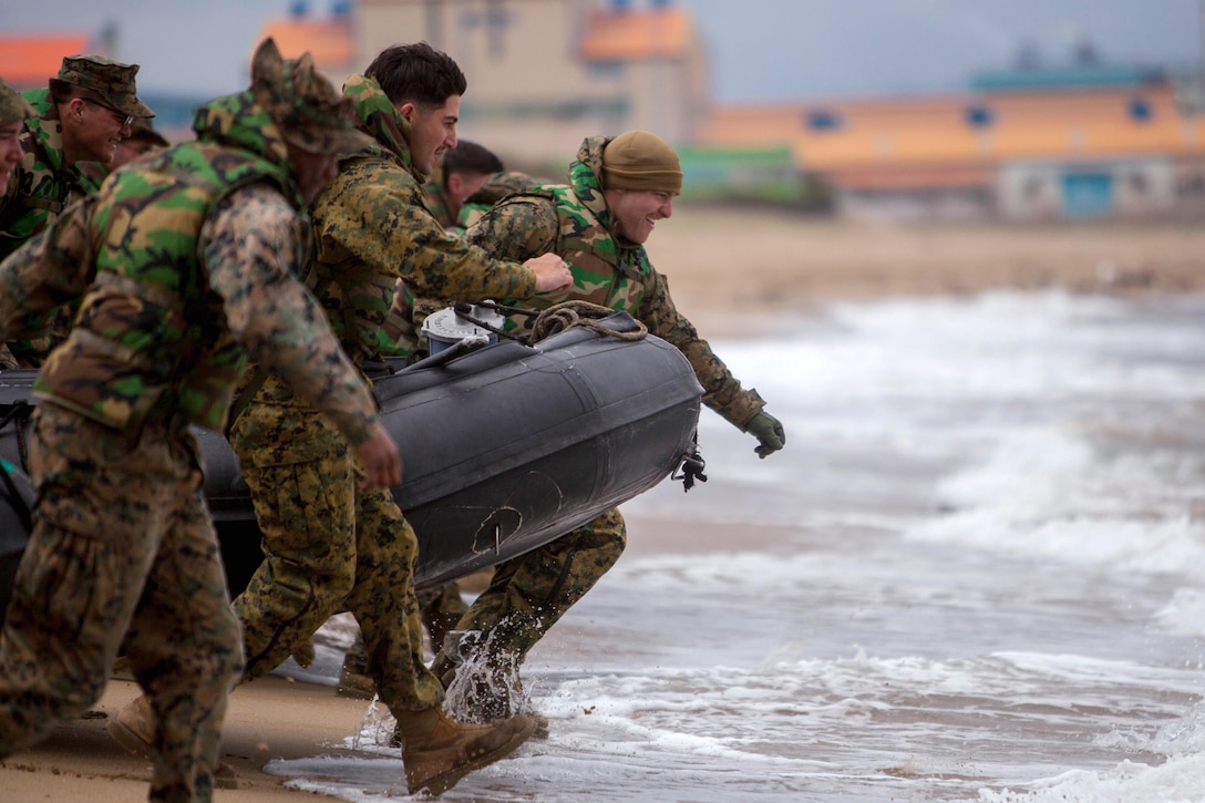 U.S. and South Korean Marines carry an inflatable boat into the water during training as a part of the Korea Marine Exchange Program in South Korea, April 4, 2016. The exchange is designed to increase interoperability and reinforce the alliance between the United States and South Korea. The U.S. Marines are assigned to 1st Battalion, 3rd Marine Regiment. Marine Corps photos by Cpl. Erick Loarca

