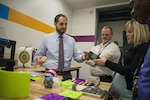 Jonathan Hopkins, a mechanical engineer and Additive Manufacturing (AM) Tiger Team member, shows fellow employees at Naval Surface Warfare Center, Carderock Division objects created through AM during a tour of the new Manufacturing, Knowledge and Education (MAKE) Lab, which officially opened in Building 60 in West Bethesda, Md., March 24, 2016. The MAKE Lab will open training and production in AM, also known as 3-D printing, to all of Carderock’s employees
who desire to participate and exchange ideas. (U.S. Navy photo by Dustin Q. Diaz/Released)