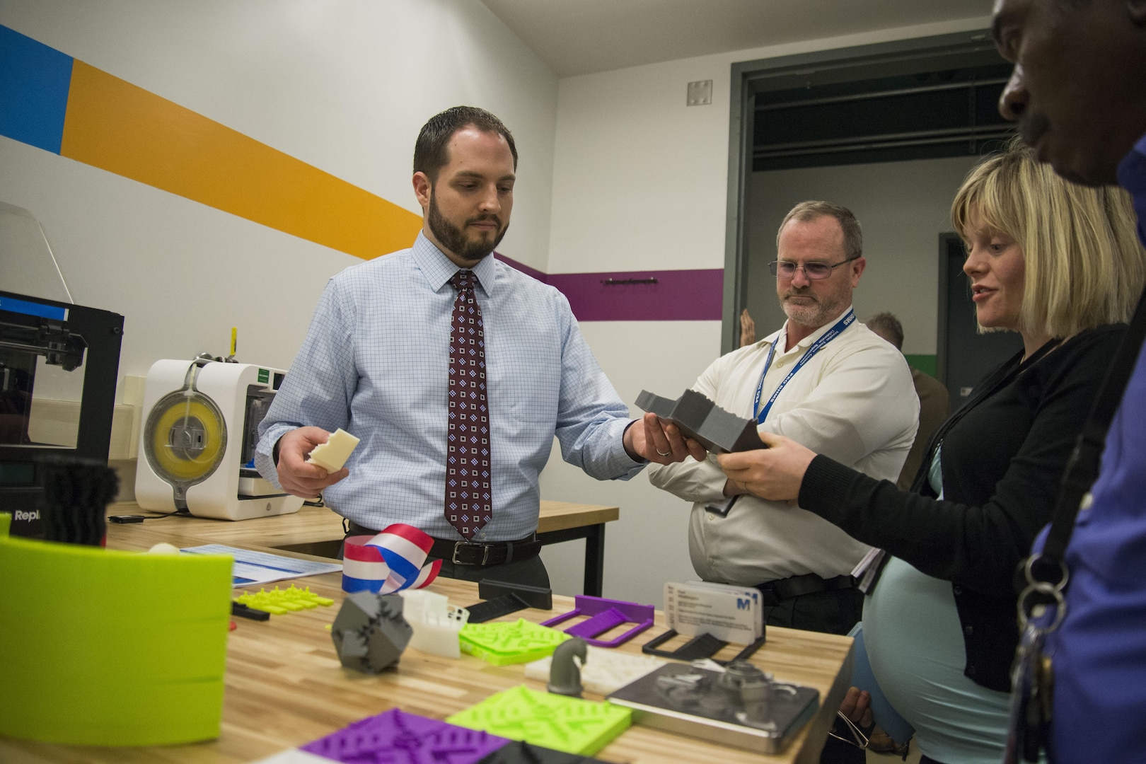 Jonathan Hopkins, a mechanical engineer and Additive Manufacturing (AM) Tiger Team member, shows fellow employees at Naval Surface Warfare Center, Carderock Division objects created through AM during a tour of the new Manufacturing, Knowledge and Education (MAKE) Lab, which officially opened in Building 60 in West Bethesda, Md., March 24, 2016. The MAKE Lab will open training and production in AM, also known as 3-D printing, to all of Carderock’s employees
who desire to participate and exchange ideas. (U.S. Navy photo by Dustin Q. Diaz/Released)