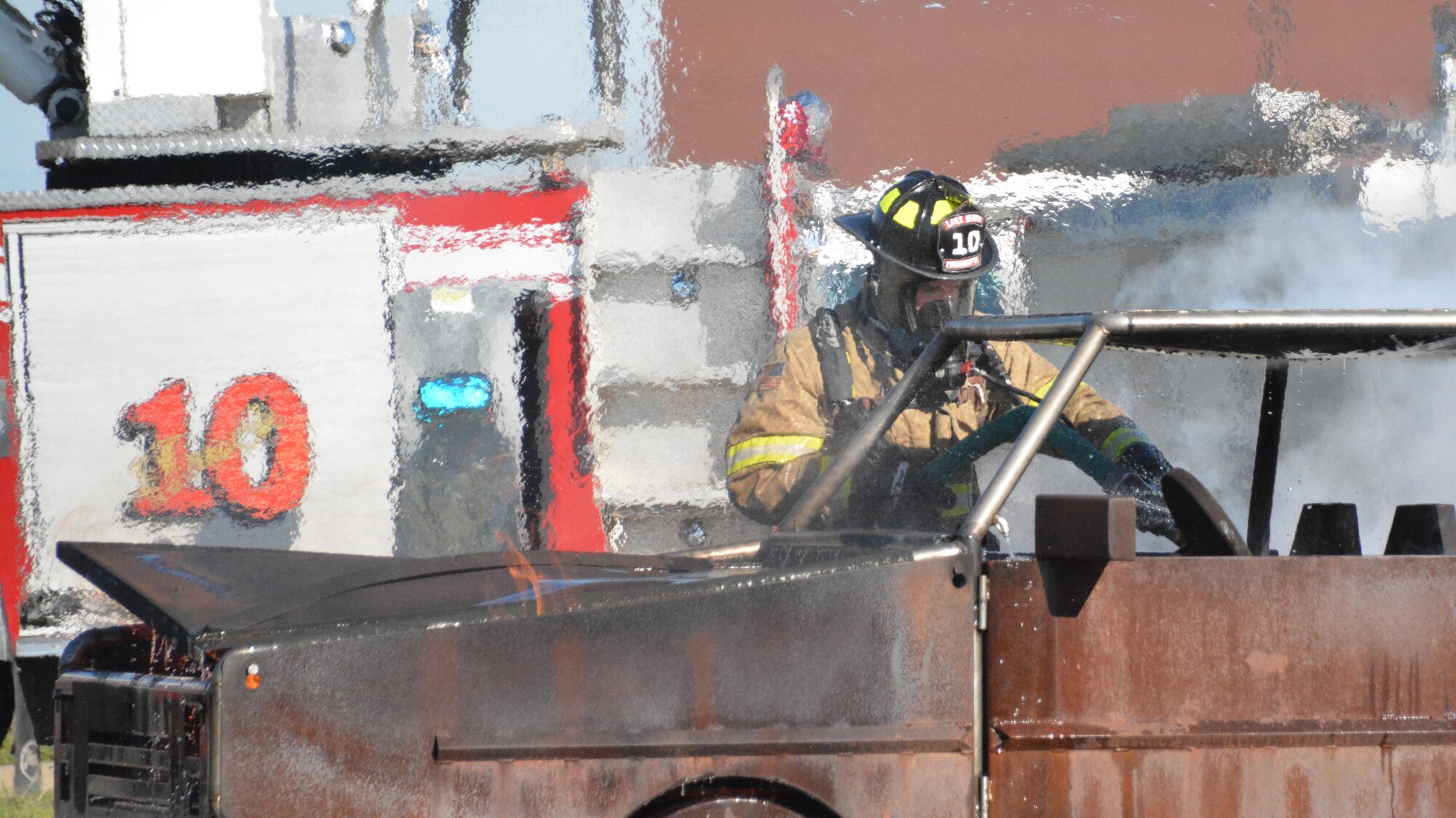A Lake Worth firefighter douses flames March 22 in a vehicle fire training simulator at Tarrant County College, Fort Worth, Texas. More than 10 emergency management agencies showed up to the college’s northwest campus to participate in a scenario involving an F-16 crash to practice multi-agency cooperation. (U.S. Air Force photo by Staff Sgt. Samantha Mathison)