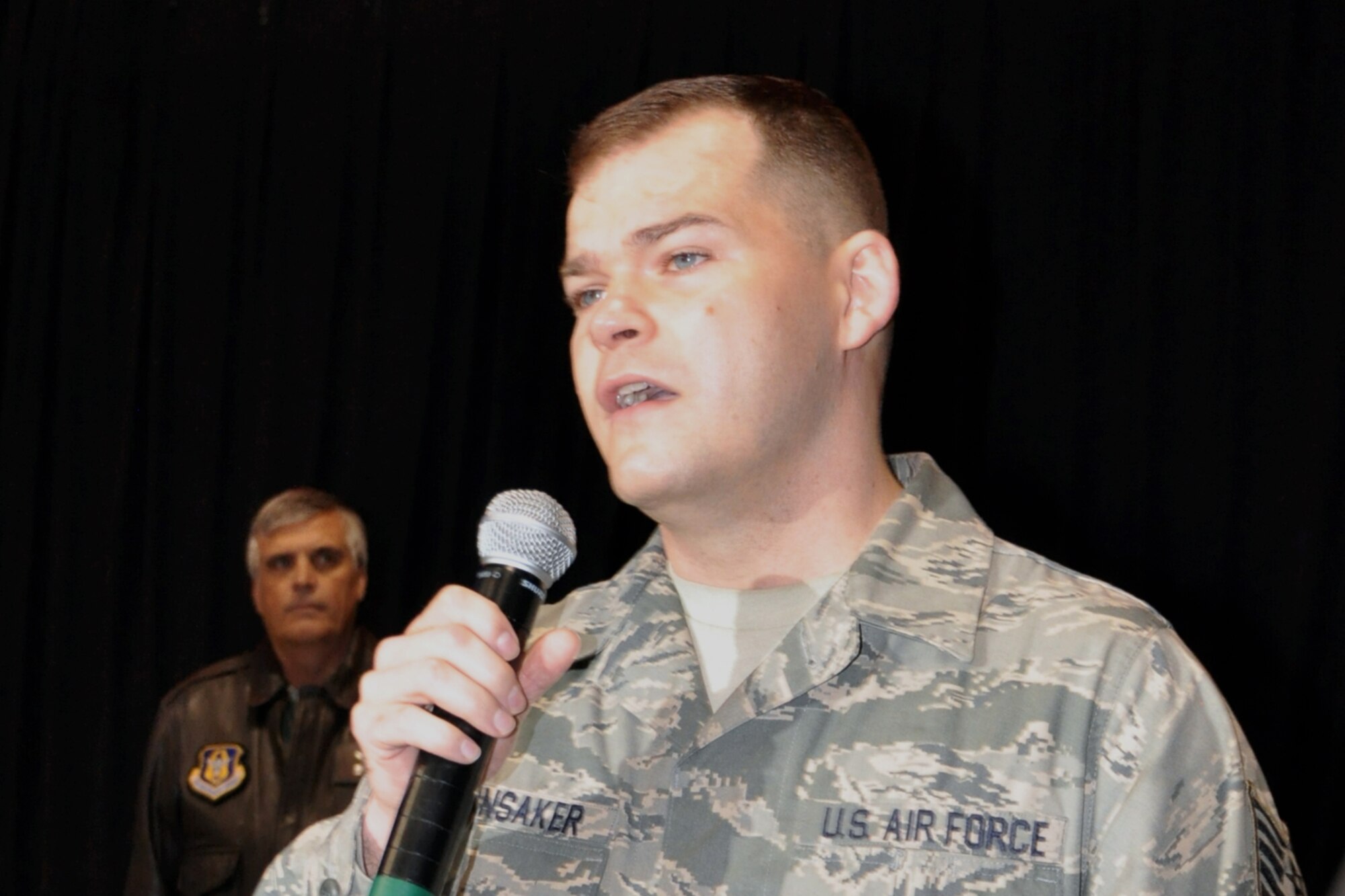Tech. Sgt. Marshall Hunsaker, a broadcast journalist assigned to the 910th Airlift Wing Public Affairs Office sings God Bless America while Col. Bill Phillips, commander of the 910th Operations Group, looks on during a Youngstown Phantoms hockey game here, April 2, 2016. A group of Citizen Airmen, based at nearby Youngstown Air Reserve Station, Ohio, participated in YARS Night Out activities before and during the game. The Phantoms, a member of the United States Hockey League, defeated the Omaha Lancers 4-1 in front of a home ice crowd of more than 3000 fans. (Courtesy Photo/Deana Barko)