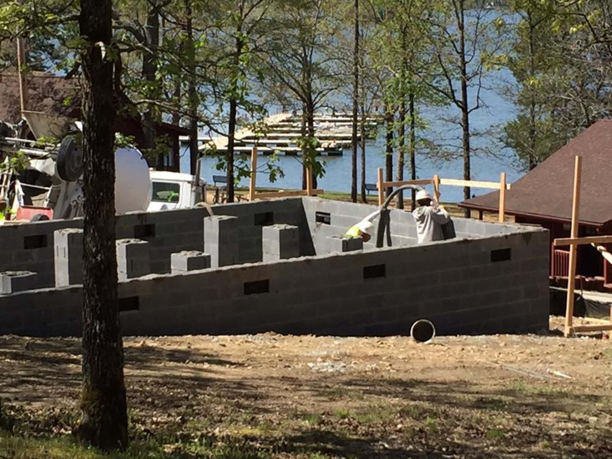 Construction workers finish laying the foundation for two new two-story, eight-person cabins at the 20th Force Support Squadron’s Wateree Recreation Area at Lake Wateree, S.C., March 29, 2016. Construction on the new cabins, originally scheduled for fiscal year 2018, began this year due to overwhelming customer demand. (Courtesy photo)