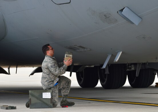 Staff Sgt. Matthew Calvo, a 736th Aircraft Maintenance Squadron communication, countermeasure and navigation system craftsman, uploads a flare magazine onto a C-17A Globemaster III on March 25, 2016, at Dover Air Force Base, Del. Each magazine consists of different flare sticks that are capable of defeating different infrared threats. (U.S. Air Force photo/Senior Airman William Johnson)