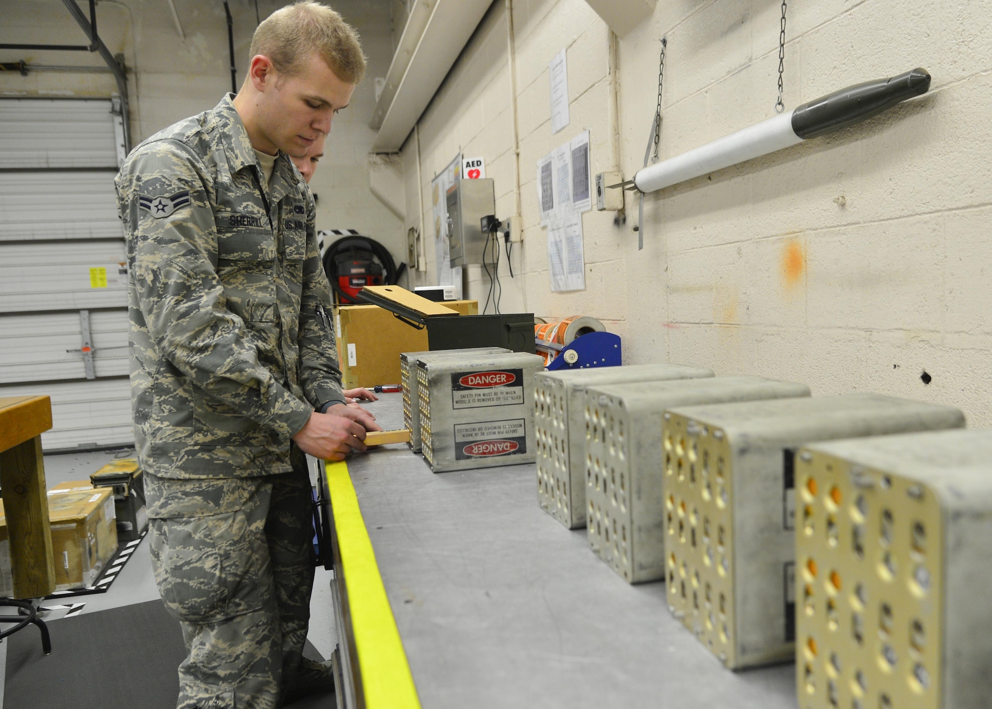 Airman 1st Class Clay Sherrill, a 436th Maintenance Squadron munitions storage crewmember, loads a flare stick into a magazine box March 28, 2016, at Dover Air Force Base, Del. Once the magazine boxes are fully loaded, they are transported to the flightline to be uploaded onto the aircraft. (U.S. Air Force photo/Senior Airman William Johnson)