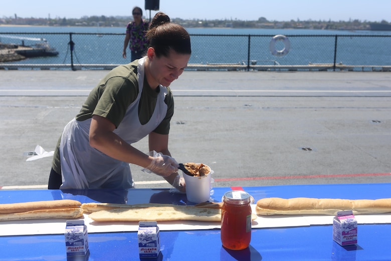 A Marine with Marine Corps Air Station Miramar’s Single Marine Program scoops peanut butter during the Stem-to-Stern PB & J challenge aboard the USS Midway Museum in San Diego, Calif., April 2, 2016. The Marines competed with 20 local Sailors to make the world’s longest peanut butter and jelly sandwich made on a military vessel.