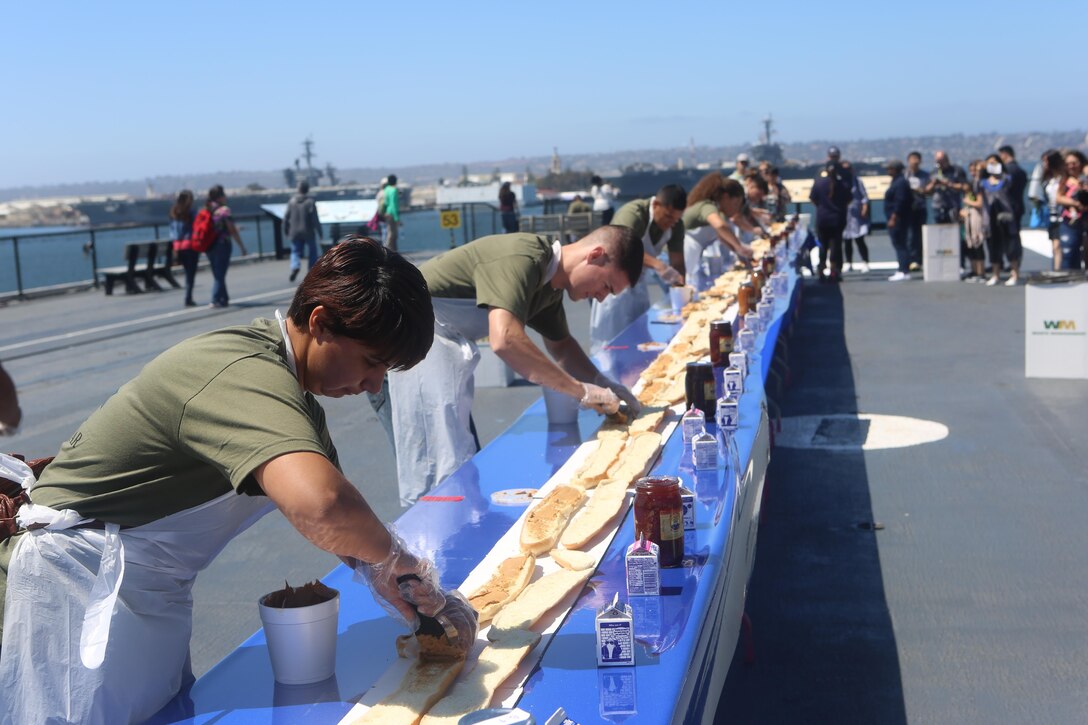 Marines with Marine Corps Air Station Miramar’s Single Marine Program make sandwiches during the Stem-to-Stern PB & J challenge aboard the USS Midway Museum in San Diego, Calif., April 2, 2016. The Marines competed with 20 local Sailors to make the world’s longest peanut butter and jelly sandwich made on a military vessel.