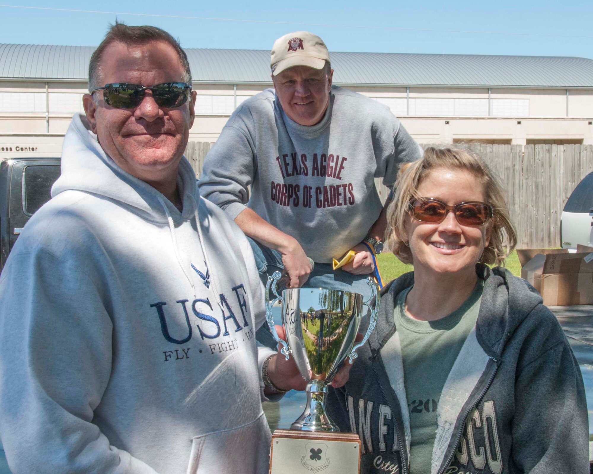 Leo Kamphaus, the commander of the 307th Maintenance Group, accepts the Commander’s Cup Champion trophy from Shelley Cohen, the Command Chief Master Sergeant for the 307th Bomb Wing, at the conclusion of the annual Wing family day. Reservists and their families were able to compete for Olympic style medals while enjoying a picnic. The Commander’s Cup is awarded to the group with the most accumulated points from all of the events. (U.S. Air Force photo by Tech. Sgt. Ted Daigle/Released)