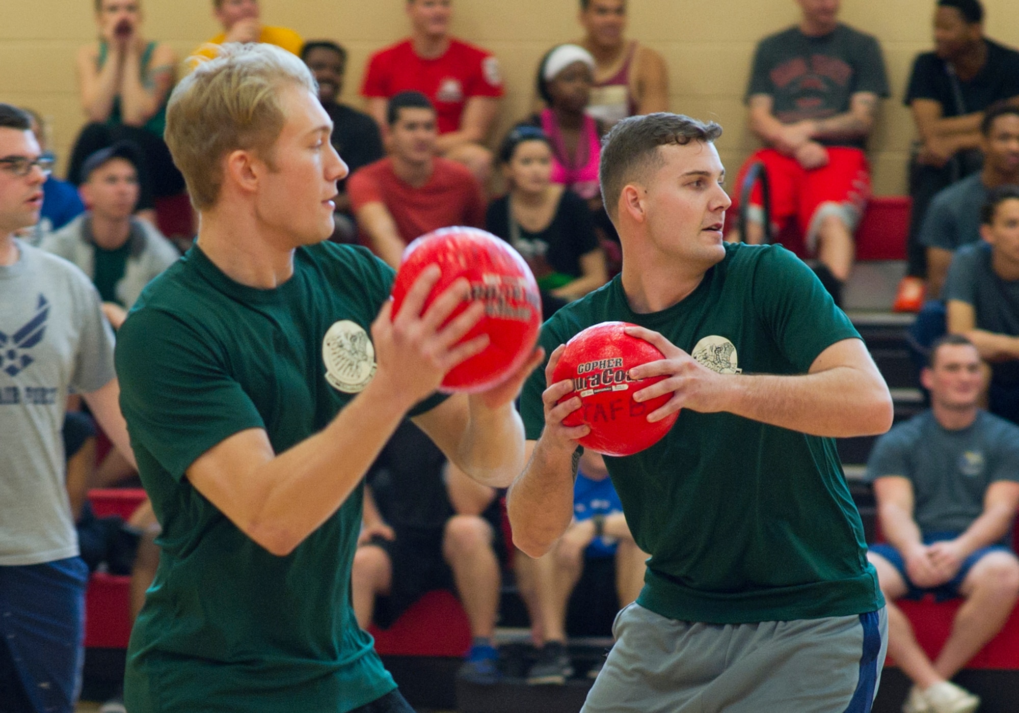 Airman 1st Class Tyler Busick (left) and Senior Airman Yaal Kand (right), 325th Contracting Squadron contracting specialists, play dodgeball during Comprehensive Airman Fitness Day April 1, at the Tyndall Fitness Center. (U.S. Air Force photo by Senior Airman Alex Fox Echols III/Released)